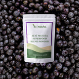 Acai matcha superfood blend powder package on a bed of acai berries