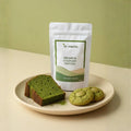 Matcha green tea product with matcha cookies and cake on a plate against a green background
