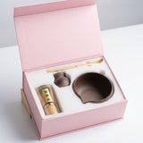 Tea set with a pink box on a white background