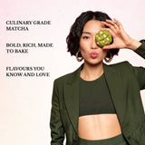 Woman holding a green matcha product in front of her eye with promotional text about culinary grade matcha.