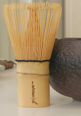 Tea bowl and whisk on a table with a blurred background